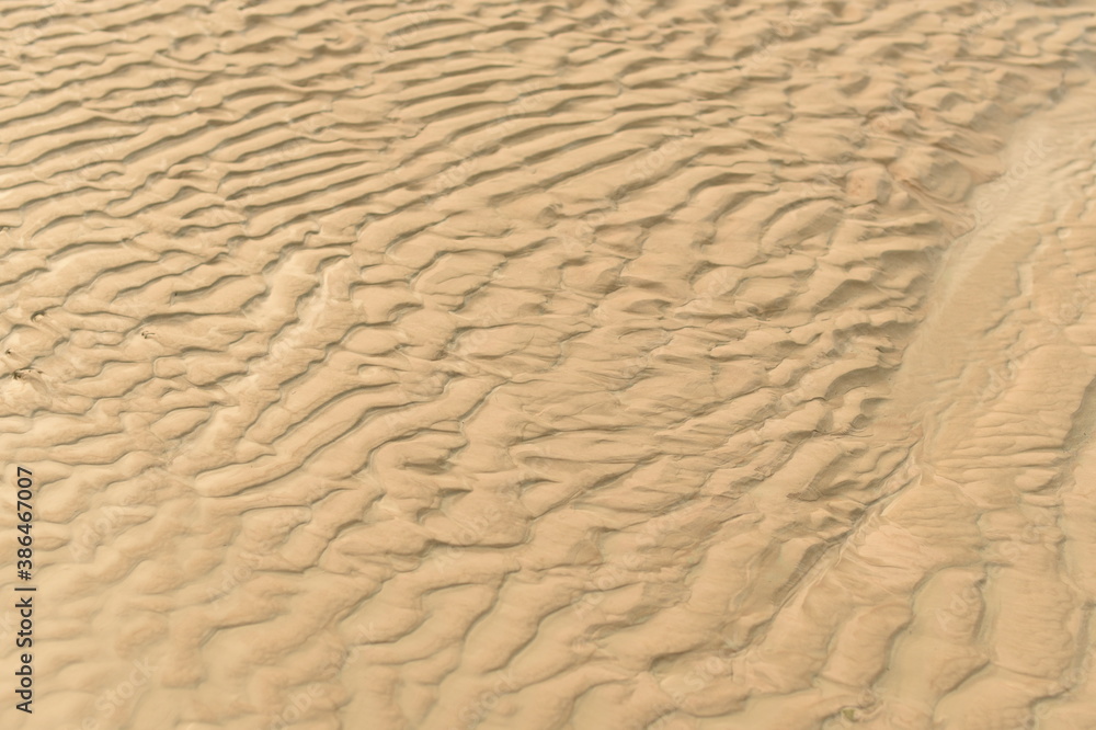 The texture of the sand by the ocean The texture of the sand by the ocean