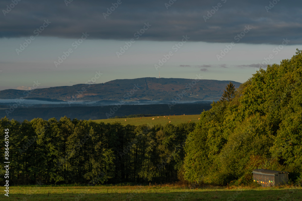 Obraz premium Sunrise time near Ceske Budejovice city in autumn morning with green forest