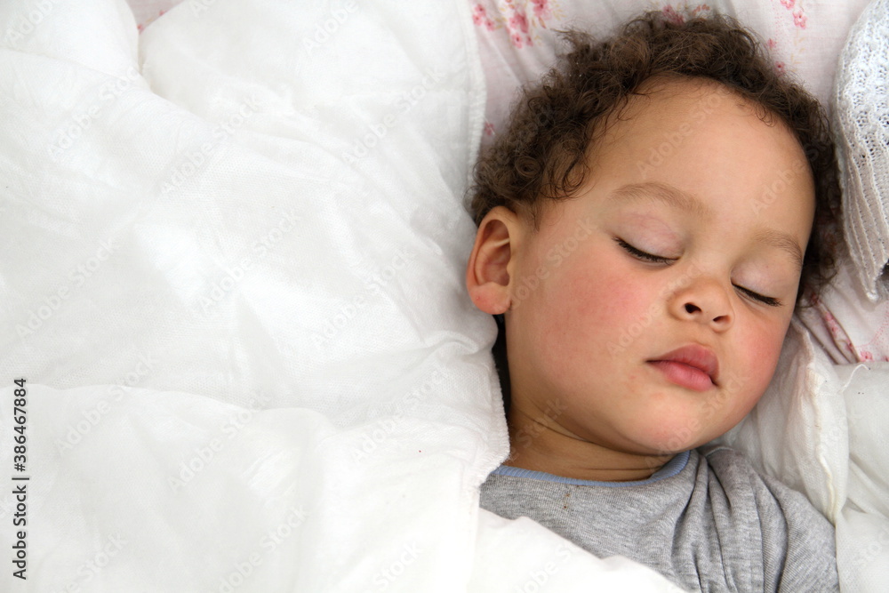 baby sleeping wrapped up in blanket after having a good sleep in bed stock photo baby sleeping wrapped up in blanket after having a good sleep in bed stock photo
