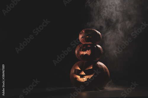 An image of a pyramid made of glowing in the dark jack o lantern for halloween photo