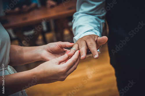n unrecognizable bride and groom exchanging of the Wedding Rings in wedding ceremony