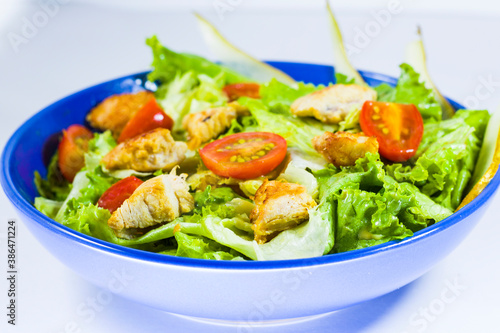 Chicken salad with greens, tomatoes and apple