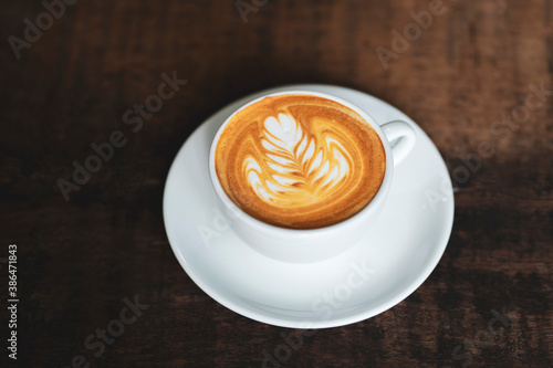 cup of latte art on the wooden table