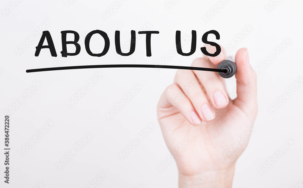 Hand writing ABOUT US with black marker on transparent wipe board Hand writing ABOUT US with black marker on transparent wipe board