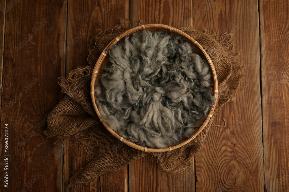 Newborn photography digital background prop. wood basket with green fur and on a wooden background