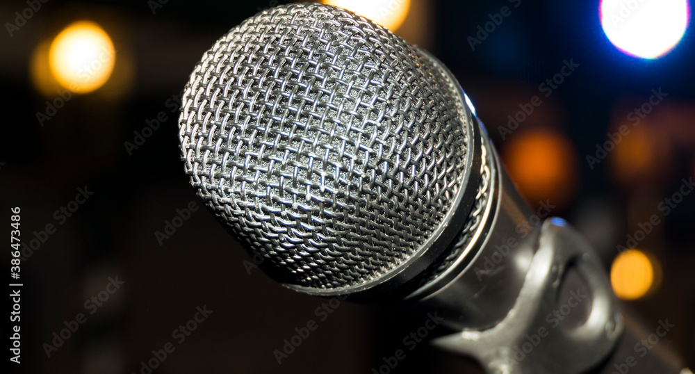 Microphone on microphone stand with blurred background black white Microphone on microphone stand with blurred background black white