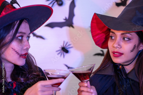 young Asian woman wearing costume in Halloween festival party photo