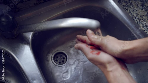 man washing hands with blood, concept of gender violence