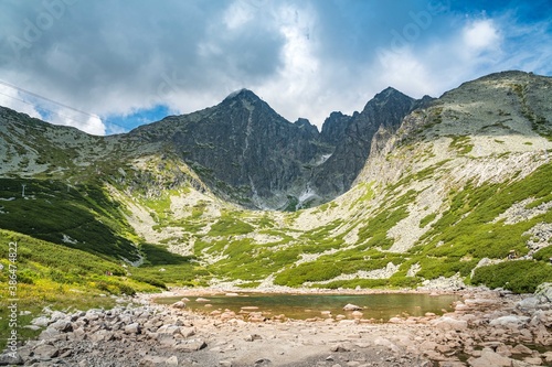 A landscape in the High Tatras with the lake Skalnate Pleso and Lomnicky peak. Summer view from national park of Slovakia