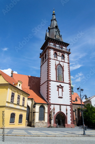 Sightseeing tower of the late gothic decanal Church of the Assumption of the Virgin Mary in Chomutov, Usti nad Labem region, Czech Republic, sunny summer day, clear blue sky background