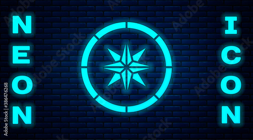 Glowing neon Compass icon isolated on brick wall background. Windrose navigation symbol. Wind rose sign. Vector.