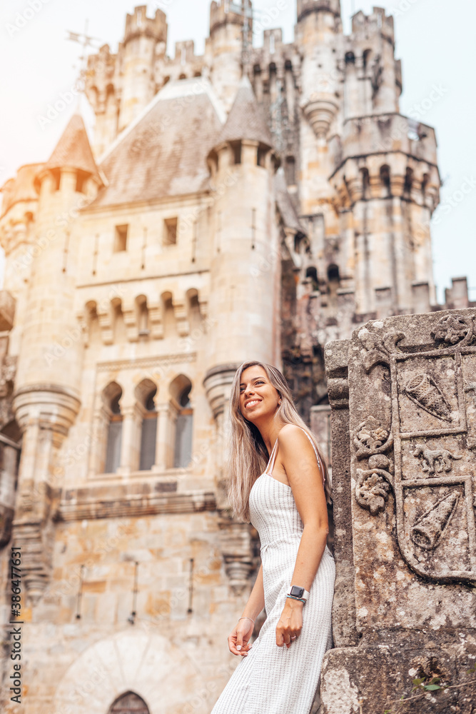 Young woman in front of a medieval castle
