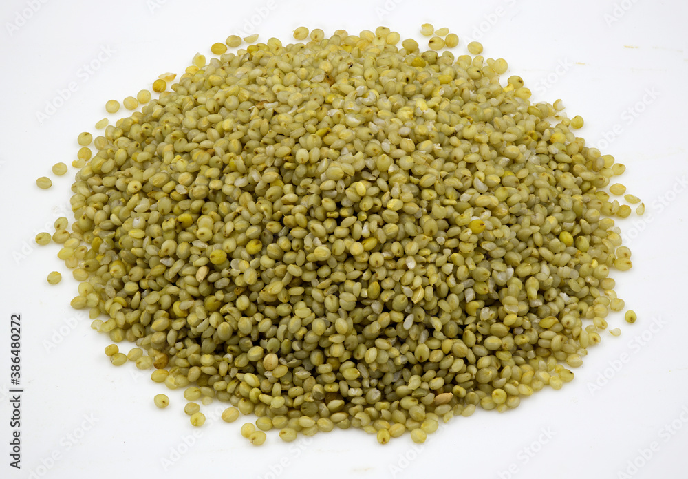 Close-up of browntop millet grains on a white background Close-up of browntop millet grains on a white background