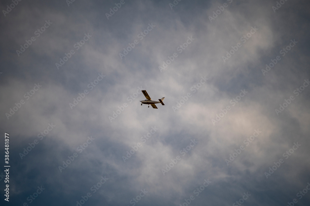 small private plane flying in the clouds
