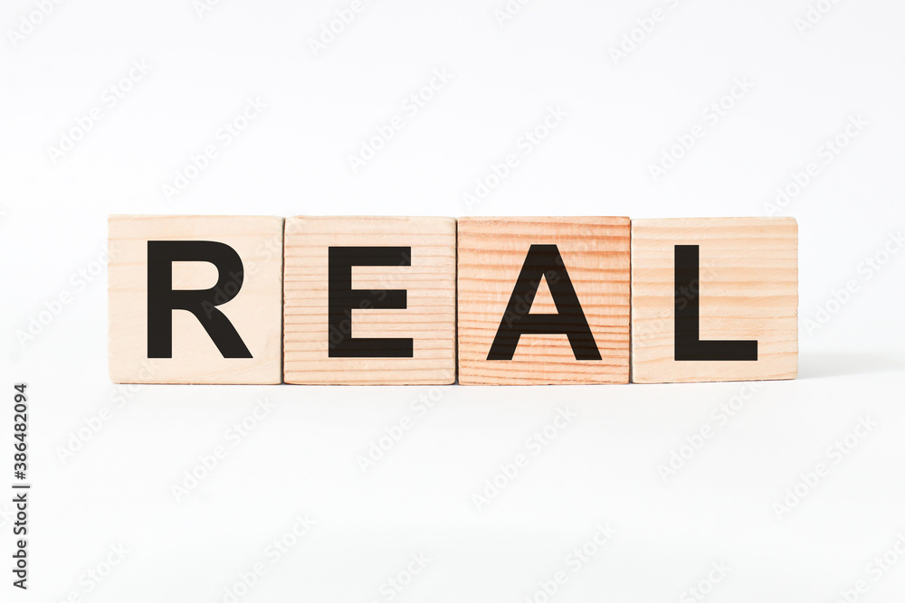word REAL on wooden blocks, white background, business concept. business and Finance word REAL on wooden blocks, white background, business concept. business and Finance