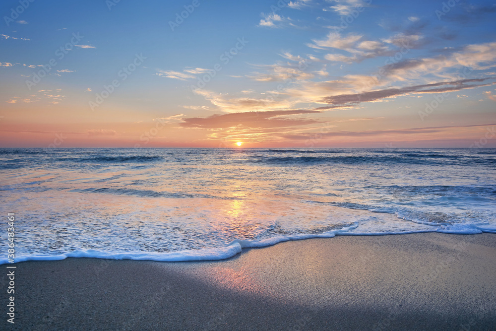 Fototapeta premium Sunset on the beach of Mar de Fora, Finisterre, Galicia, Spain. This beach is the westernmost beach in Europe, so people go there to see one of the most impressive sunsets in Northern Spain