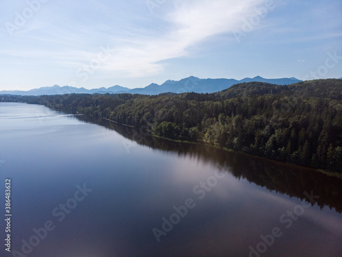 Aerial view of forest at lake Staffelsee with blue sky and clouds in the background