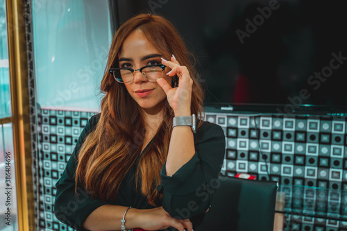 Mujer joven mexicana latina trabajando en oficina de empresa feliz alegre photo