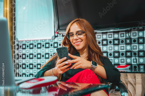 Mujer joven mexicana latina trabajando en oficina de empresa feliz alegre photo