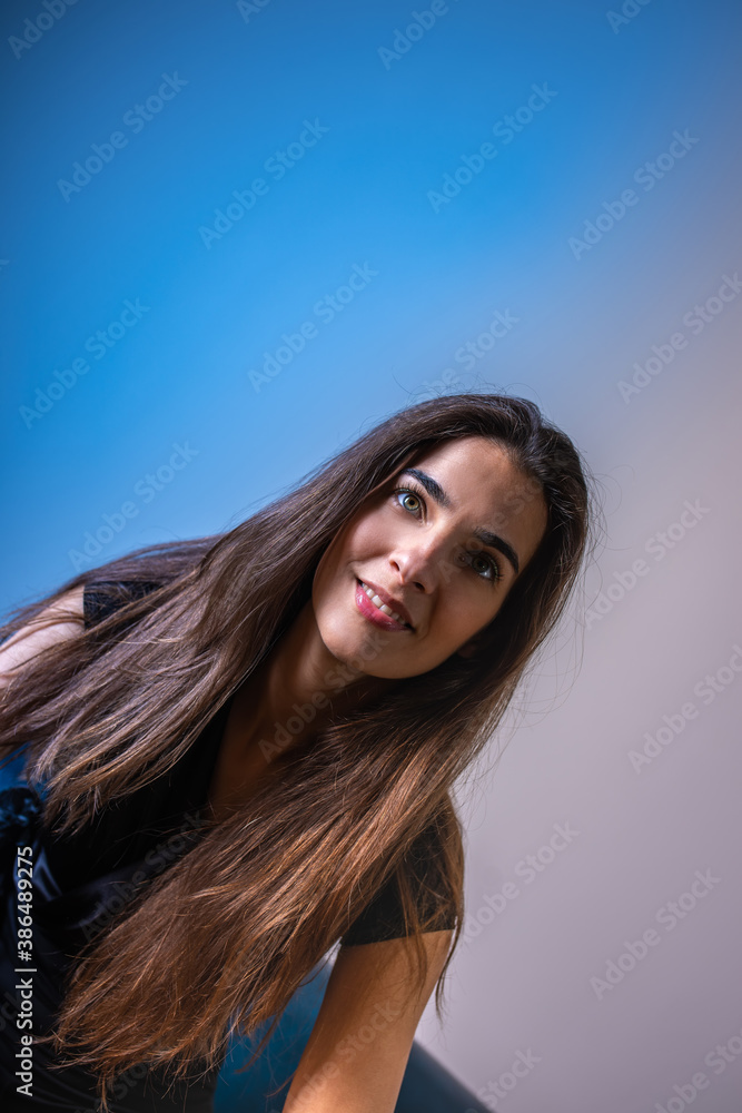 A smiling young woman sitting on a sofa A smiling young woman sitting on a sofa