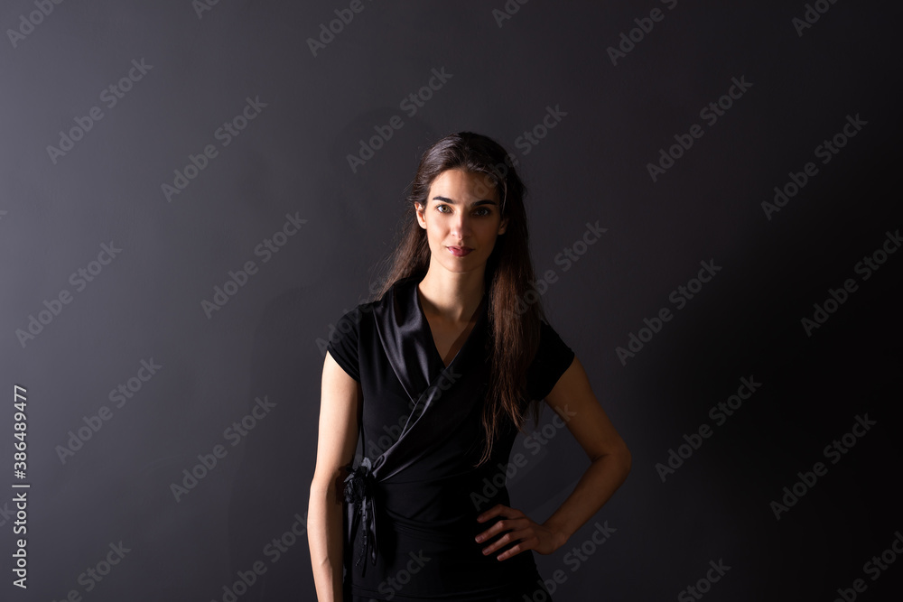 A smiling young woman standing in the studio A smiling young woman standing in the studio