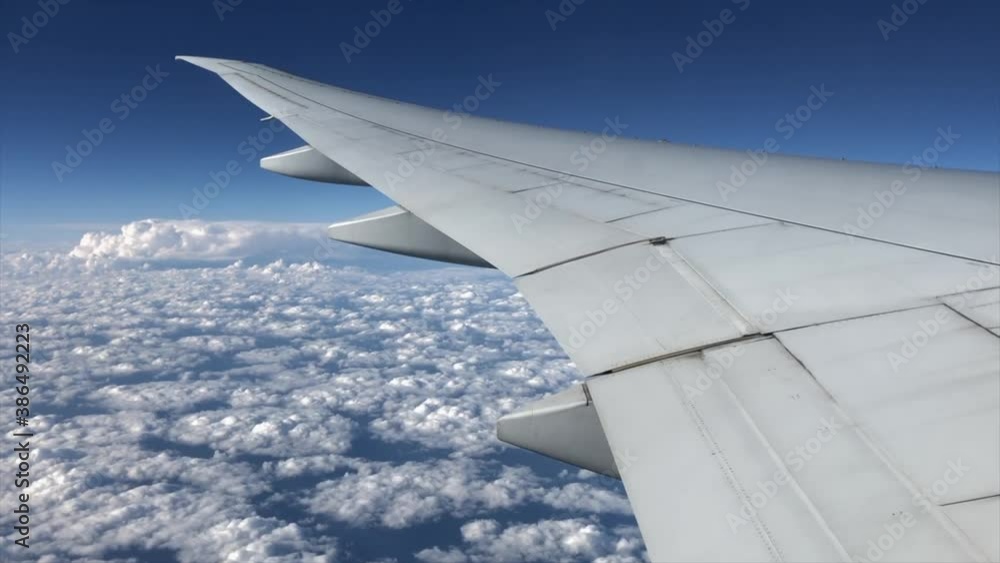 Wing of the airplane against cloudy sky Wing of the airplane against cloudy sky