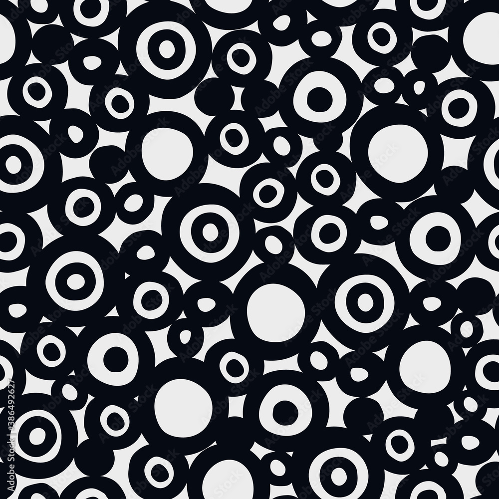 Seamless geometric pattern with hand drawn uneven black rings of different size on white background for surface design and other design projects Seamless geometric pattern with hand drawn uneven black rings of different size on white background for surface design and other design projects