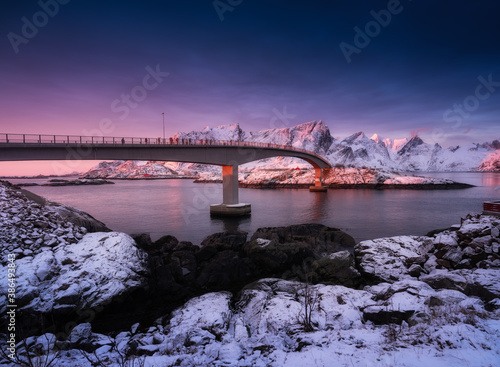 View on the bridge in the Hamnoy village, Lofoten Islands, Norway. Landscape in winter time during blue hour at sunrise. Mountains and water. Travel - image