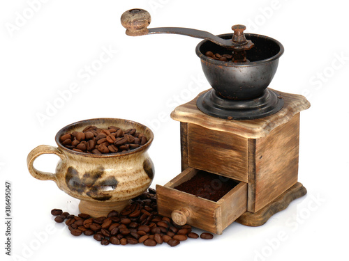 Coffee in a clay cup and ground in an old vintage grinder.