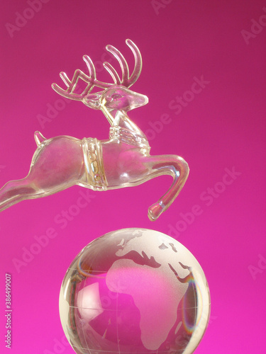 christmas card with reindeer toy on pink background