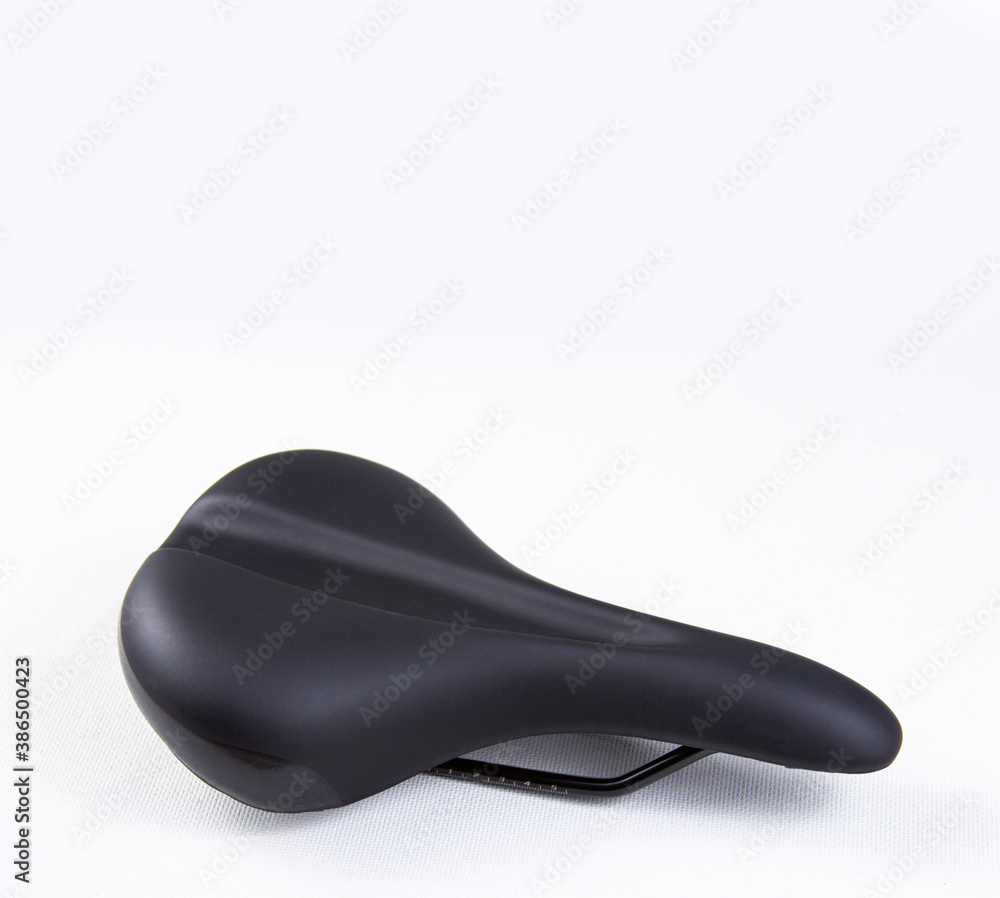 Bicycle saddle black on white background, close-up view, studio photo. Vertical orientation Bicycle saddle black on white background, close-up view, studio photo. Vertical orientation