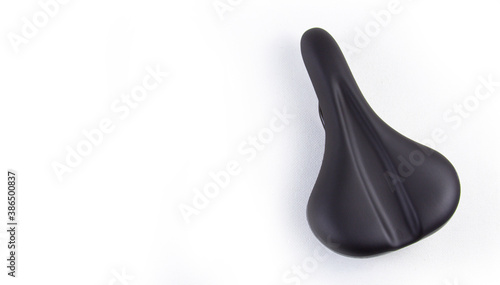 Bicycle saddle in black on a white background, close-up top view. copyspace for text.