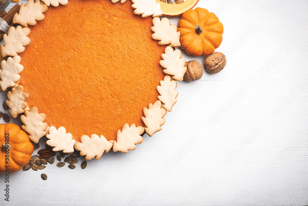 Delicious homemade pumpkin pie on white wooden table, flat lay. Space for text Delicious homemade pumpkin pie on white wooden table, flat lay. Space for text