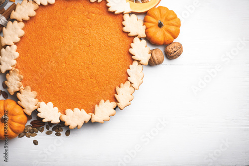 Delicious homemade pumpkin pie on white wooden table, flat lay. Space for text