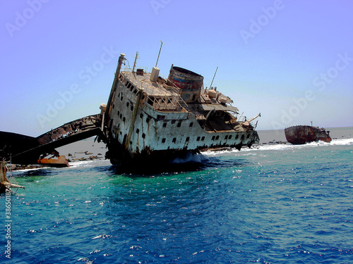Shipwreck - remains of a ship stranded on a coral island in the sea