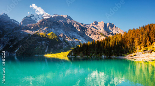 Panoramic view of the lake Oeschinensee in sunny day. Location place Swiss alps, Kandersteg district, Europe.