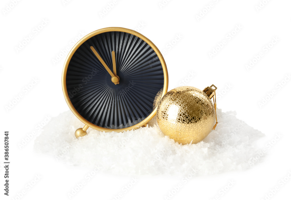 Alarm clock and Christmas ball in pile of snow on white background. New Year countdown