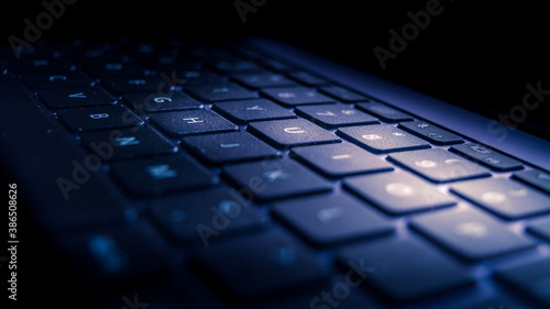 Laptop keyboard backlight from display in a dark room