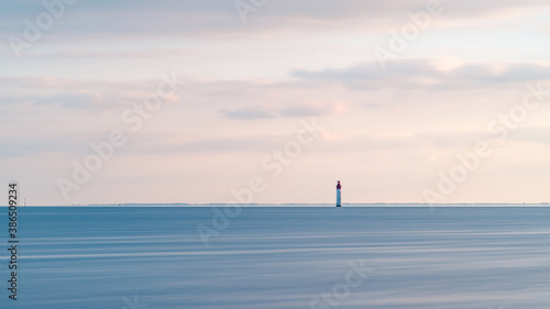 Beautiful seascape at sunset with Chauveau lighthouse. Rivedoux, Re Island, France. calm concept