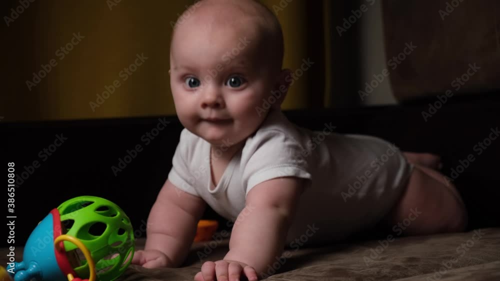 6 month old caucasian infant baby boy playing with toy at home. Early childhood development concept. 6 month old caucasian infant baby boy playing with toy at home. Early childhood development concept.