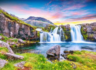 Papier peint photo Pourpre Dramatic view on Kirkjufellsfoss waterfall  near Kirkjufell mountain at sunset  © pilat666