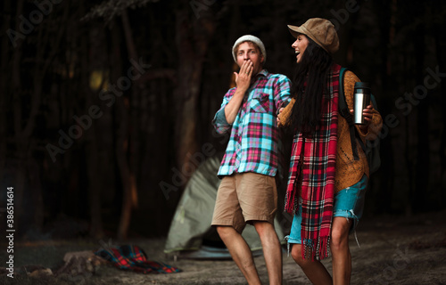 Shot of a happy couple camping on the nature. Couple in love. Camping photo. Romantic lovers. Fun. Life. 