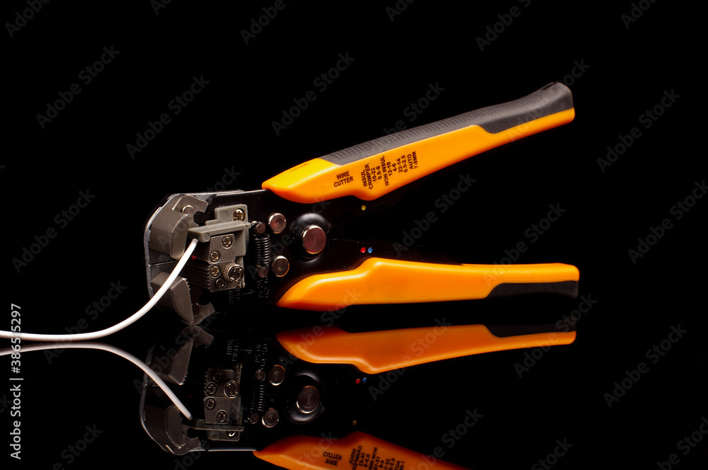 Cable insulation stripping tool isolated on black Cable insulation stripping tool isolated on black