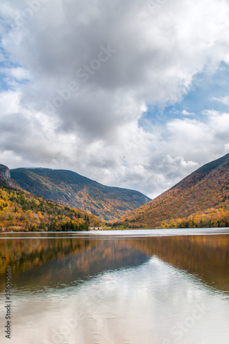 Beautiful lake in front of the the mountains in the fall in New England
