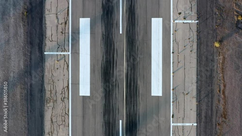 Aerial pass over an airport runway with landing tire marks. photo