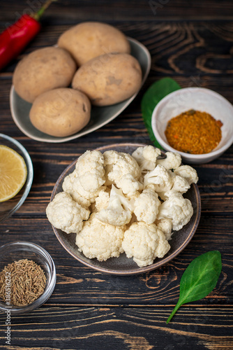 Aloo Gobi Ingredient set. Traditional spicy vegetarian indian curry dish with potatoes, cauliflower, spinach with spices