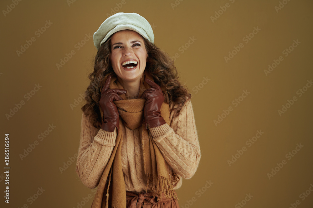 happy woman looking up at copy space on bronze background happy woman looking up at copy space on bronze background