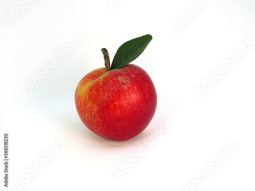 Nice red apple with green leaf. 