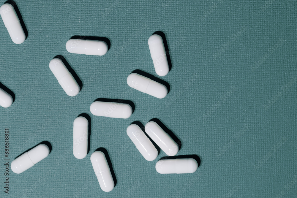 close up. lots of pills on a dark green background. close up. lots of pills on a dark green background.