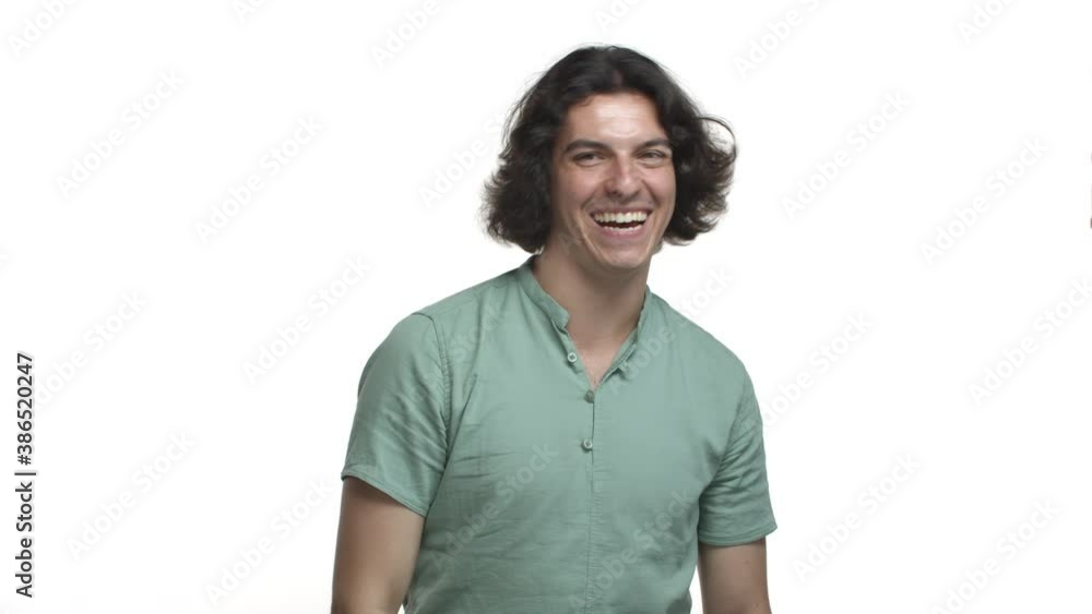 Handsome modest guy in green shirt, waving away and smiling humble, grateful for compliment, standing over white background Handsome modest guy in green shirt, waving away and smiling humble, grateful for compliment, standing over white background
